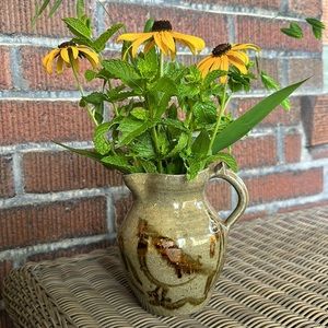 Small handmade art pottery pitcher with bird design.